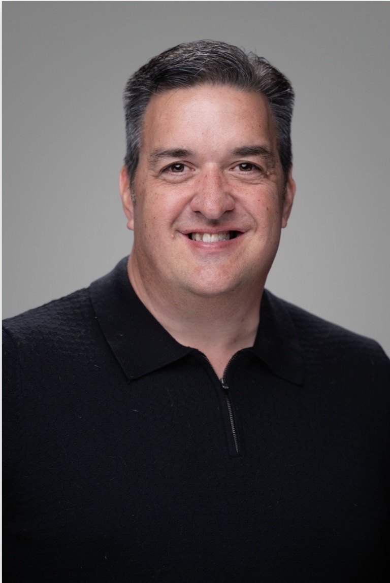 Adam McCallister smiling in his professional portrait
